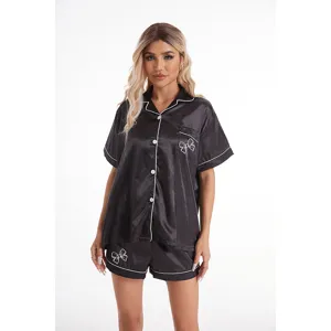 Conjunto de pijama de satén negro con lazo, parte superior de manga corta y pantalones cortos.