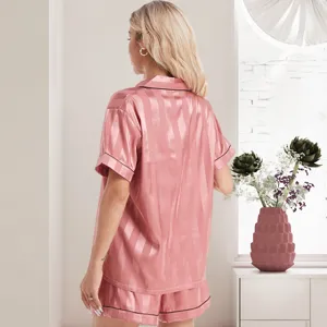 Detail view of women pink striped silk pajama set, short sleeve lapel top and shorts for home.