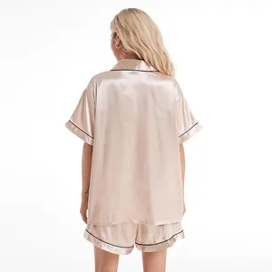 Back view of women's short sleeve satin pajama set with elegant black piping detail.