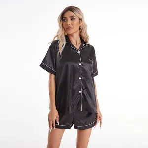 Women's black satin short sleeve pajama set with white piping, comfortable sleepwear.