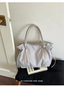 Detail view of a large capacity casual canvas tote shoulder bag in light grey with side drawstrings.