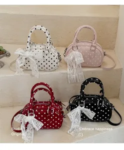 Stylish polka dot handbag with lace bow detail, cute shoulder crossbody bag for women.