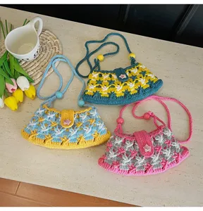 Handmade crochet crossbody bag featuring vibrant color blocking and cute floral button design.