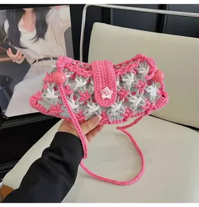 Detailed view of the cute pink crochet crossbody bag featuring a star button and knit strap.