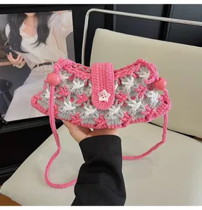 Handmade crochet shoulder bag detail, pink and grey star pattern with cute button decor.
