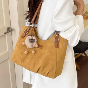 Vintage large capacity women shoulder bag, casual commuting tote with cute plush keychain.