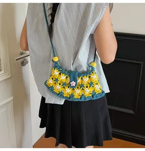 Handmade crochet shoulder bag featuring yellow and white floral pattern and cute beads.