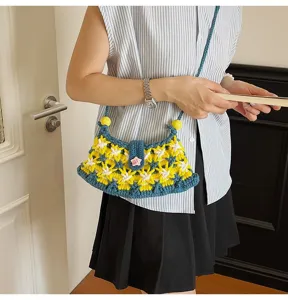 Handmade crochet crossbody bag detail view, chic blue and yellow floral knit design.