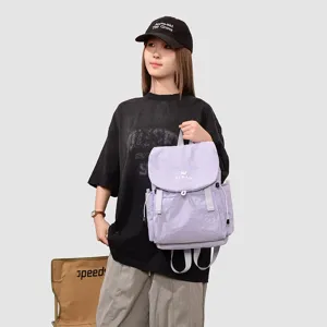 Détail de sac à dos de voyage violet clair, avec fermeture à cordons et poches pratiques.
