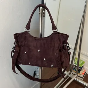 Chic brown suede shoulder bag for women, retro studded hobo underarm bag with adjustable strap.