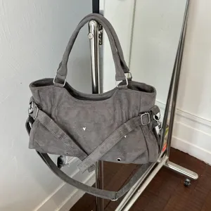 Grey suede shoulder bag for women, retro rivet underarm bag with chic crossbody strap design.