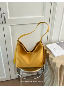 Vintage yellow hobo shoulder bag detail, stylish minimalist design for autumn daily commute.