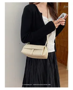 Detail view of a stylish beige woven mini crossbody square bag, chic retro vibe outfit.
