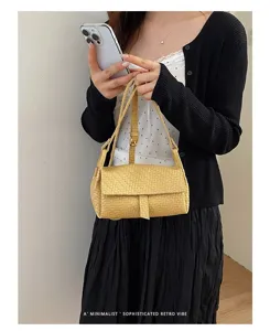 Detailed view of women's trendy woven crossbody bag, stylish mini yellow square purse.