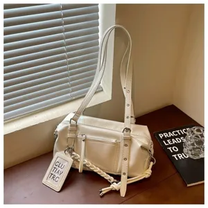 Detailed view of the white fashion shoulder pillow bag showing the texture, zipper, and hanging tag.