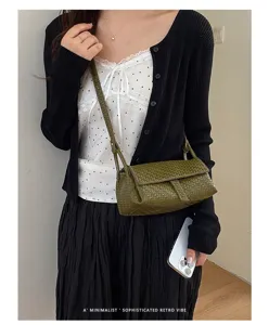 Detailed view of a stylish green woven mini crossbody bag, perfect for summer daily wear.