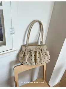 Sac porté épaule beige pour femme, élégant sac seau sous les bras avec joli nœud et poignées.