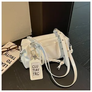 Detailed view of white chic pillow shoulder bag with trendy design, premium faux leather material.