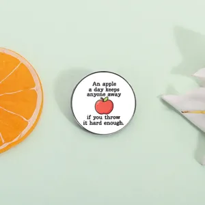 Creative round metal brooch badge featuring funny apple text quote, perfect accessory for backpacks.