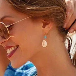 Fashion summer shell earrings with blue bead and gold hook, trendy beach jewelry for women.