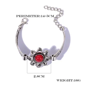 Detail view of vintage silver flower bracelet with red center stone and adjustable chain link.
