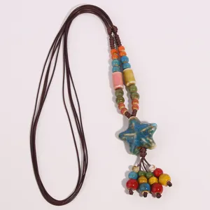 Detail view of the ethnic ceramic long necklace featuring colorful beads and star pendant.