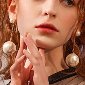 Elegant long double pearl drop earrings with delicate gold chain, chic fashion jewelry.