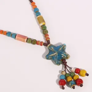 Ethnic ceramic starfish pendant long necklace detail featuring colorful glazed beads.
