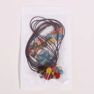 Ethnic style ceramic long necklace with starfish pendant and colorful beads, detail view.