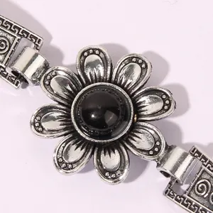 Retro vintage silver-tone floral bracelet featuring a striking black center stone detail.