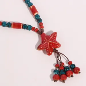 Ceramic starfish pendant long necklace ethnic style sweater chain jewelry detail view photo.