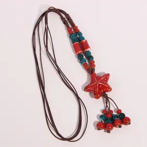 Ceramic starfish pendant necklace detail, ethnic beaded sweater chain, adjustable cord.