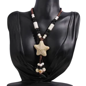 Close-up detail of the ceramic starfish pendant and beaded long necklace on display model.