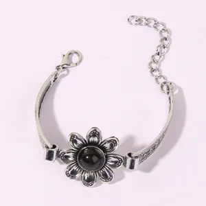 Vintage silver floral bracelet detail shot with black stone center and adjustable extension chain.