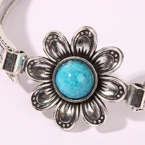 Detailed close-up view of vintage silver flower bracelet featuring blue turquoise stone.