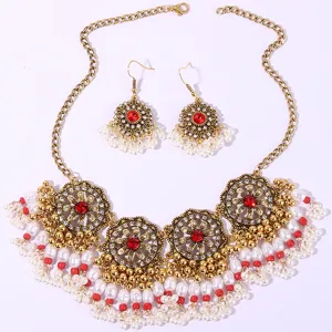 Bohemian vintage gold-tone necklace and earrings set with red stones and white pearls detail