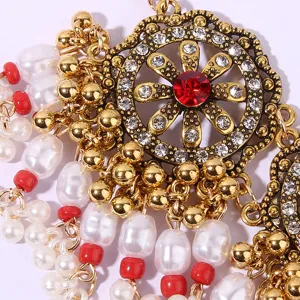 Bohemian vintage rhinestone pearl pendant detail, exquisite gold-tone ethnic necklace piece.