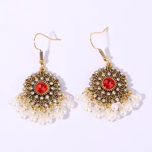Vintage gold tone red crystal flower rhinestone and pearl dangle earrings detailed view.