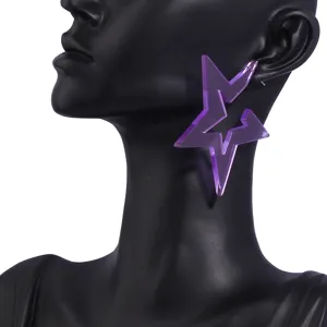 Close-up detail of oversized purple acrylic star earrings, perfect for party and vacation wear.