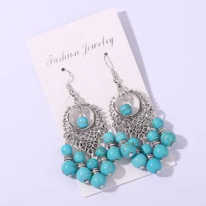 Detailed shot of retro turquoise tassel earrings, Bohemian style Tibetan silver drop earrings.
