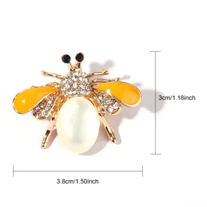 Gold bee brooch with shimmering rhinestones, pearl body and yellow enamel wings for women.