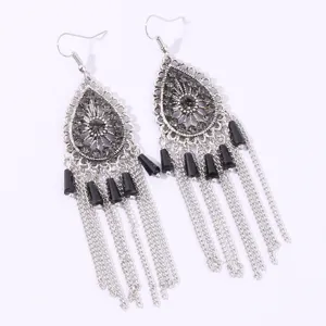 Bohemian silver teardrop rhinestone tassel earrings detailed close-up shot showing crystal design.