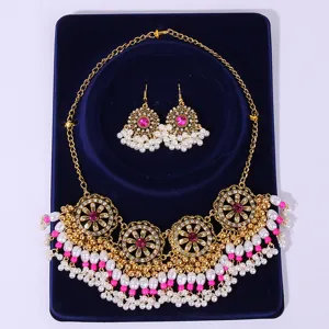 Exquisite bohemian palace style necklace and earrings set with pearl tassels and pink crystal details.