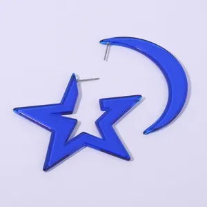 Blue acrylic star and moon earrings detail view showing the glossy texture and metal pins.