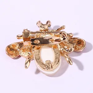Detailed view of the gold-tone bee brooch back pin mechanism, showing quality alloy craftsmanship.