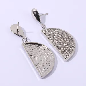 Detailed view of silver rhinestone semi-circle drop earrings, sparkling chic jewelry design.