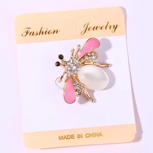 Rhinestone bee brooch detail view, sweet insect design with pink enamel wings and pearl body.