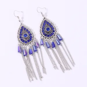 Bohemian blue rhinestone teardrop tassel earrings detail view, ethnic silver metal drop jewelry.