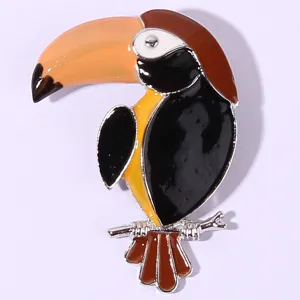 Close-up of colorful toucan enamel brooch, vivid animal design with exquisite metallic luster.