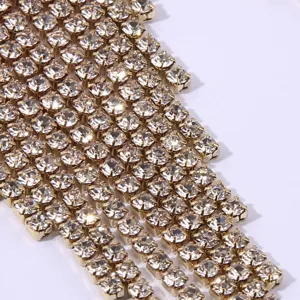 Close-up detail of sparkling rhinestone tassel chain earrings, elegant shiny fashion jewelry.